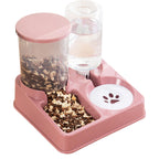 Pink pet feeder and waterer combo with a clear food storage container, clear water bottle, and white bowl on a white background.